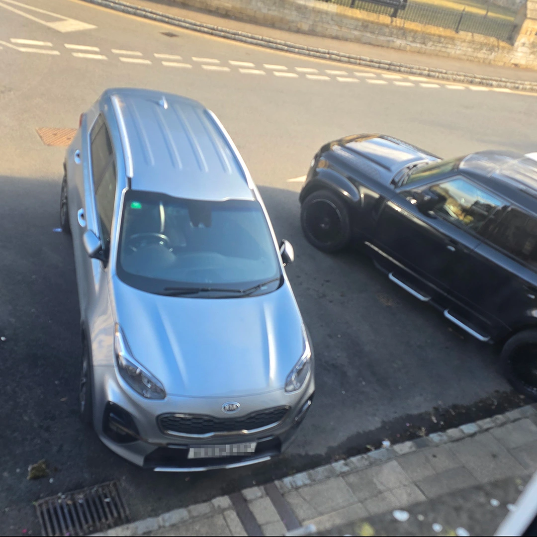 Parked in two spaces